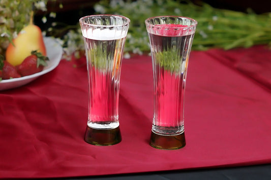 Set of 6 ribbed borosilicate juice glasses with green base, elegant and lightweight drinkware for any setting.